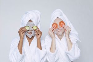 Two women applying home remedies to reduce dark circles and rejuvenate their under-eye area.