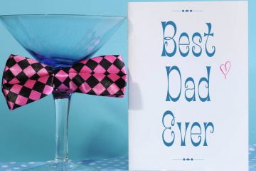 Happy Fathers Day, Best Dad Ever, greeting card with blue martini glass and fun pink check bow tie, on blue and polka dot background.