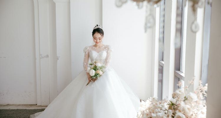 Radiant bride in a stunning white wedding gown, embodying timeless beauty.