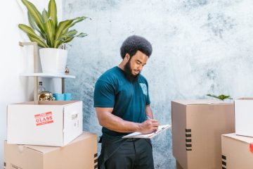 A man inspecting mobile storage boxes for organization and functionality.