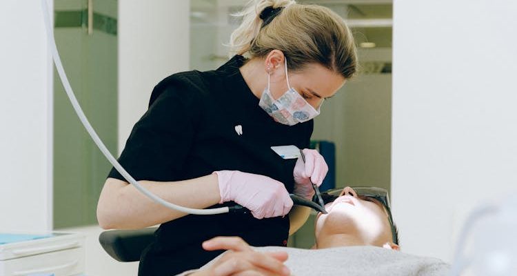 A dentist examining a patient in a dentistry clinic.