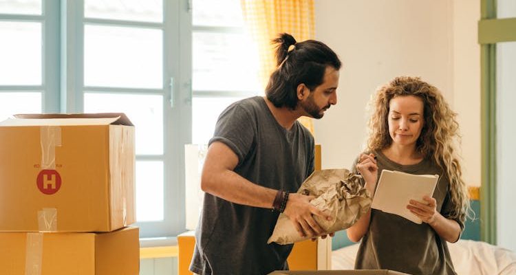 A couple reviewing a moving home checklist, ensuring all tasks are completed for a smooth transition.