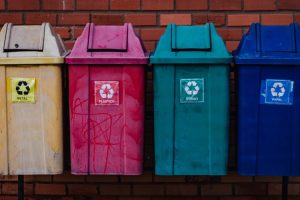 Image showcasing effective waste management with various types of labeled dustbins for recycling and disposal.