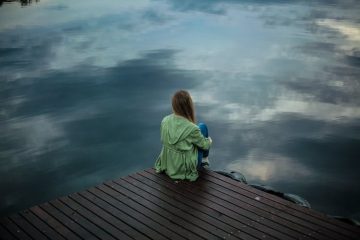 Solitary woman with PTSD, sitting in contemplation.