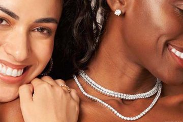 Elegant women showcasing a sparkling diamond tennis necklace gracefully.